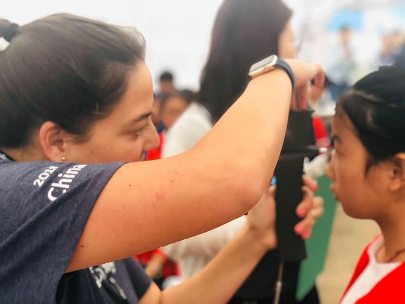 Dr. Bond examining a child's eyes