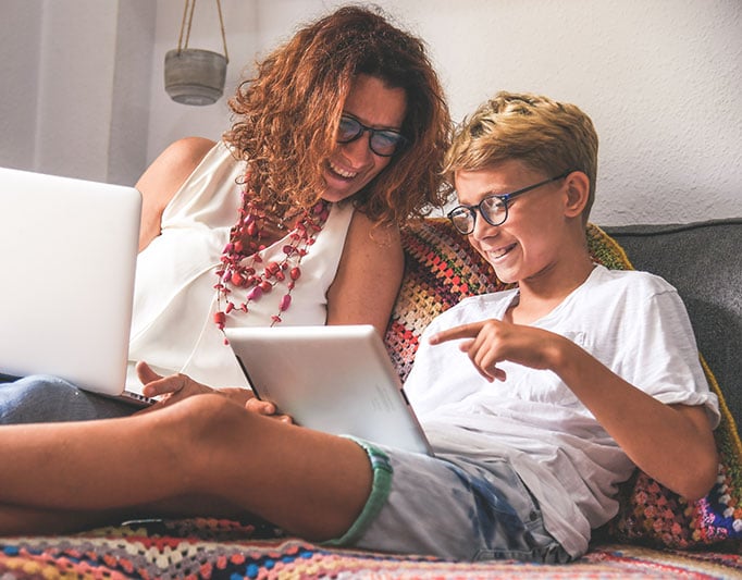 a mother and son browsing the internet on a tablet