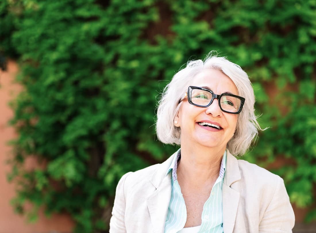 Older woman smiling with glasses